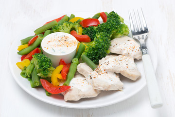 healthy food - chicken, steamed vegetables and yoghurt sauce