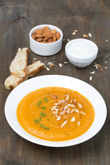 plate of carrot soup with almonds and watercress