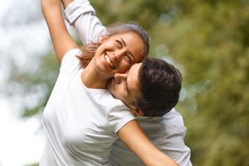 Obraz premium Young Happy Couple Hugging and Laughing