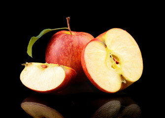 Close-up shot sliced red apple with leaf isolated