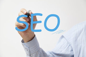 Hand writing SEO. Concept for technology