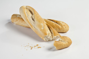 bruised baguette on a white background