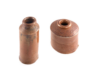 Vintage clay ink wells on a white background.