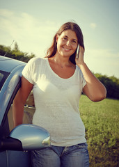 Young Driver Woman on the phone by car