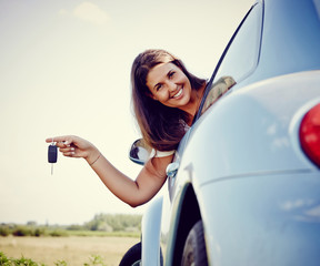 Happy Young car woman showing car keys