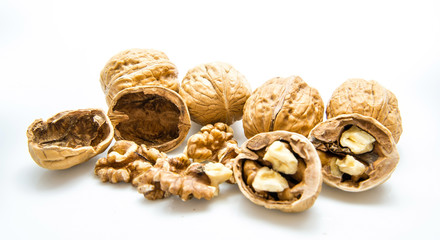 walnut and a cracked walnut on the white background