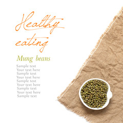 Raw Organic mung beans in a bowl on a white background
