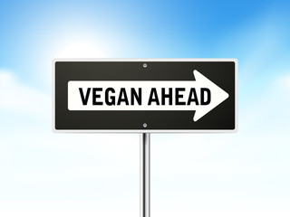 vegan ahead on black road sign