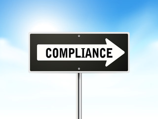 compliance on black road sign