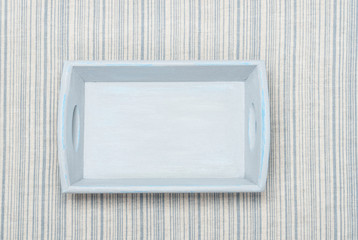 Old Painted Wooden Tray On Natural Linen Striped Textile