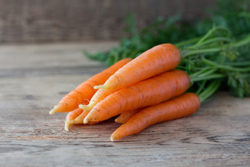 Some fresh carrots on old wooden desk