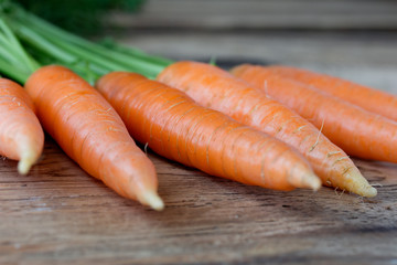 Some fresh carrots on old wooden desk