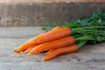 Some fresh carrots on old wooden desk