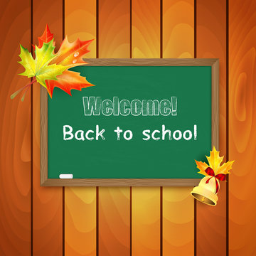 Blackboard decorated with autumn maple leaves on background a wo