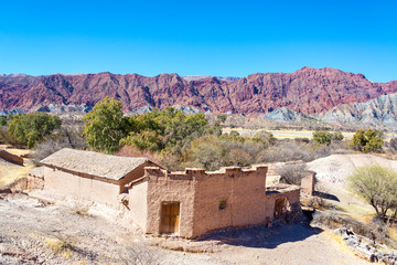 Rustic Adobe Building and Red Hills