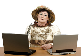 Old woman looking at computer very cautiously