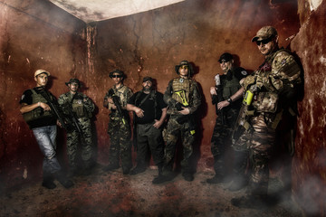 Airsoft group team in daytime action in pose
