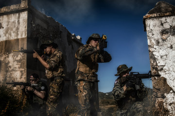 Airsoft group team in daytime action walking