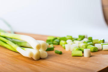 Spring green onion on wooden board