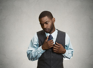 Portrait Shy, socially awkward business man, grey background 