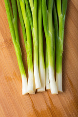 green onion on wooden board