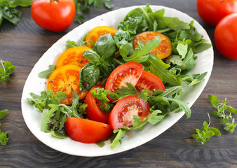 Red and yellow tomatoes with rocket salad