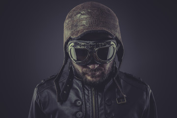 ww2 pilot dressed in vintage style leather cap and goggles - obrazy, fototapety, plakaty
