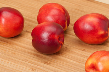 Fresh Nectarine Fruits On Wooden Board