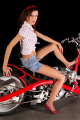 Fototapeta na wymiar chopper styled motorbike with a beautiful pinup girl