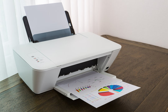 Printer with financial documents on a wood table
