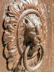 knocker in wood and bronze
