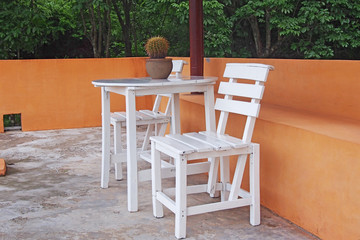 white table and chairs on concrete floor