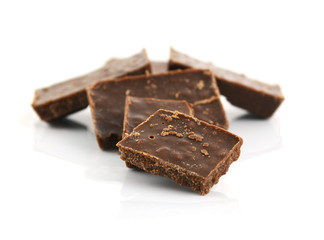 Closeup detail of chocolate parts on white background.