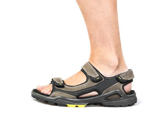 Men's foot in sandals on a white background