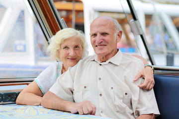 Senior couple enjoying boat trip on the canals of Amsterdam