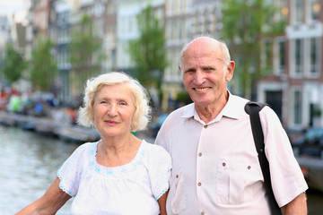 Active senior couple enjoying canal views in Amsterdam