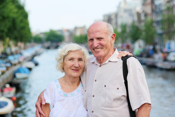 Active senior couple enjoying canal views in Amsterdam