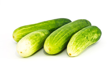 The green cucumbers on white background
