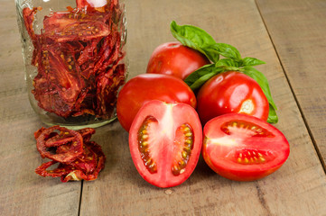 Fresh red paste tomatoes with basil and jar