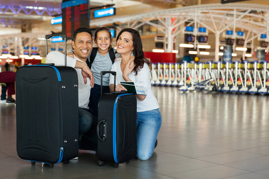 family with luggage bags at airport