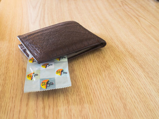 condoms in brown wallet