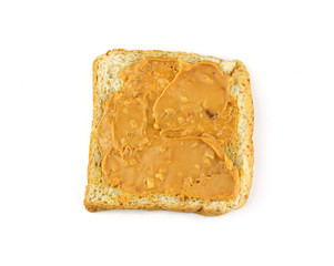 An open faced peanut butter sandwich on white bread