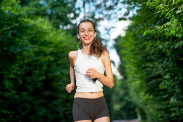 Running woman. Female runner jogging during outdoor workout in a
