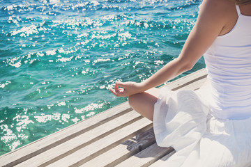 Woman meditating at the sea