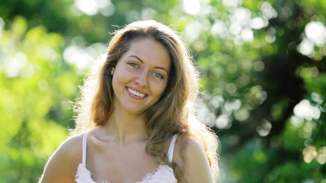 Outdoor portrait of happy long-haired  woman