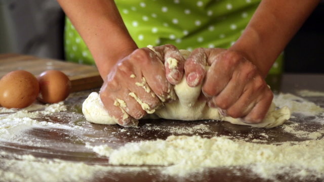 Closeup of housewife cooking  dough