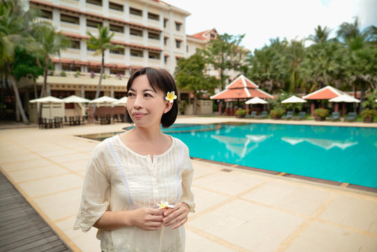 Middle Aged Woman Walking By Pool In Hotel