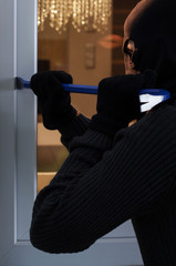 Burglar breaking into the house