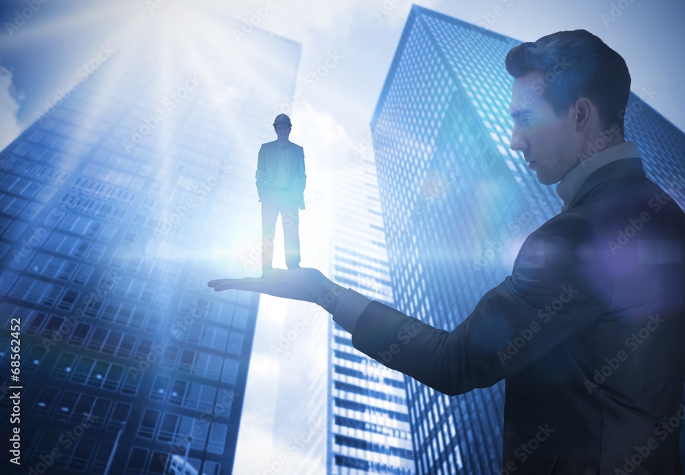 Poster composite image of businessman holding architect