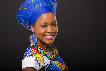 zulu woman in traditional clothes on black background